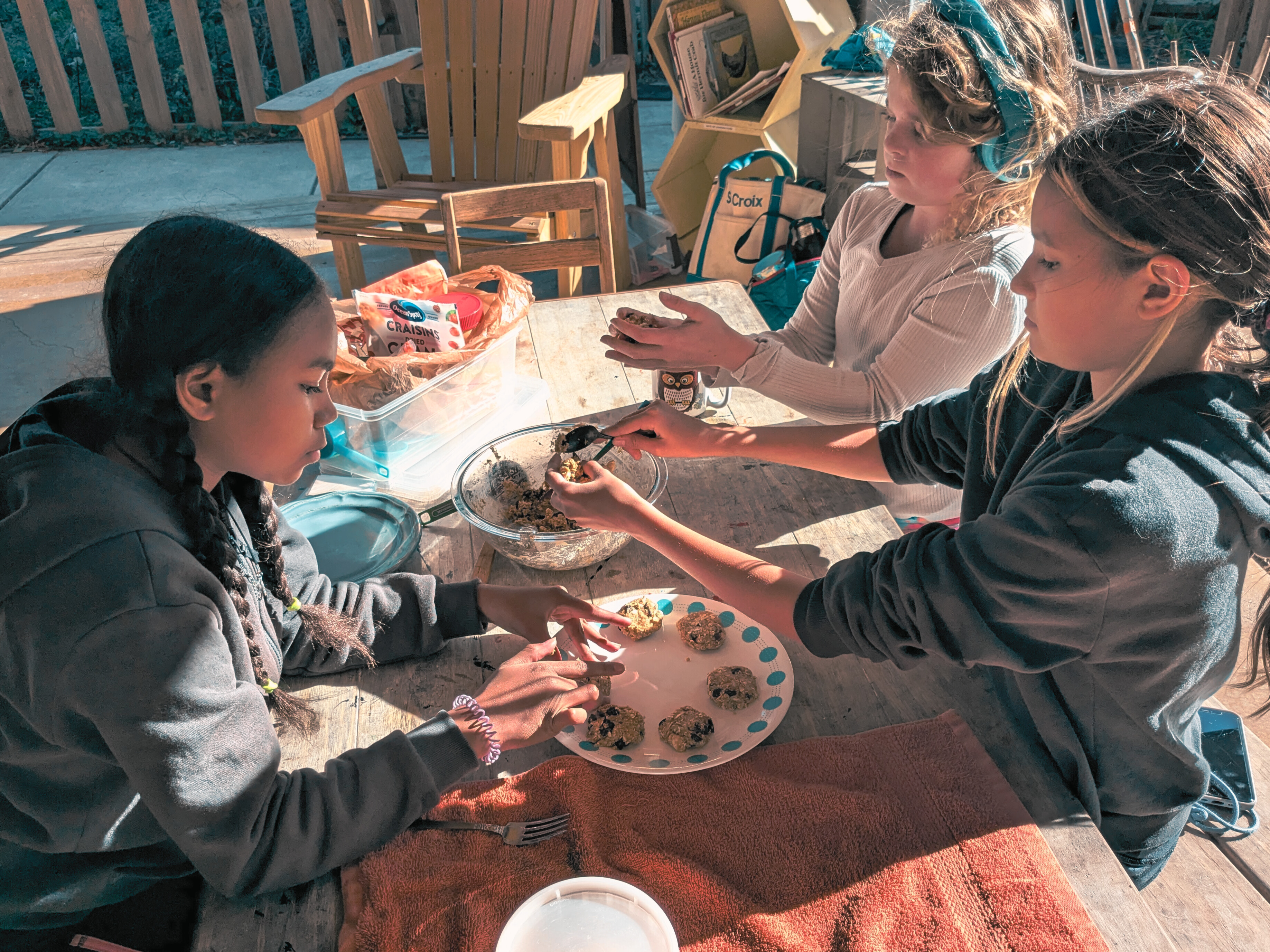 Children collaborating on baking cookies together