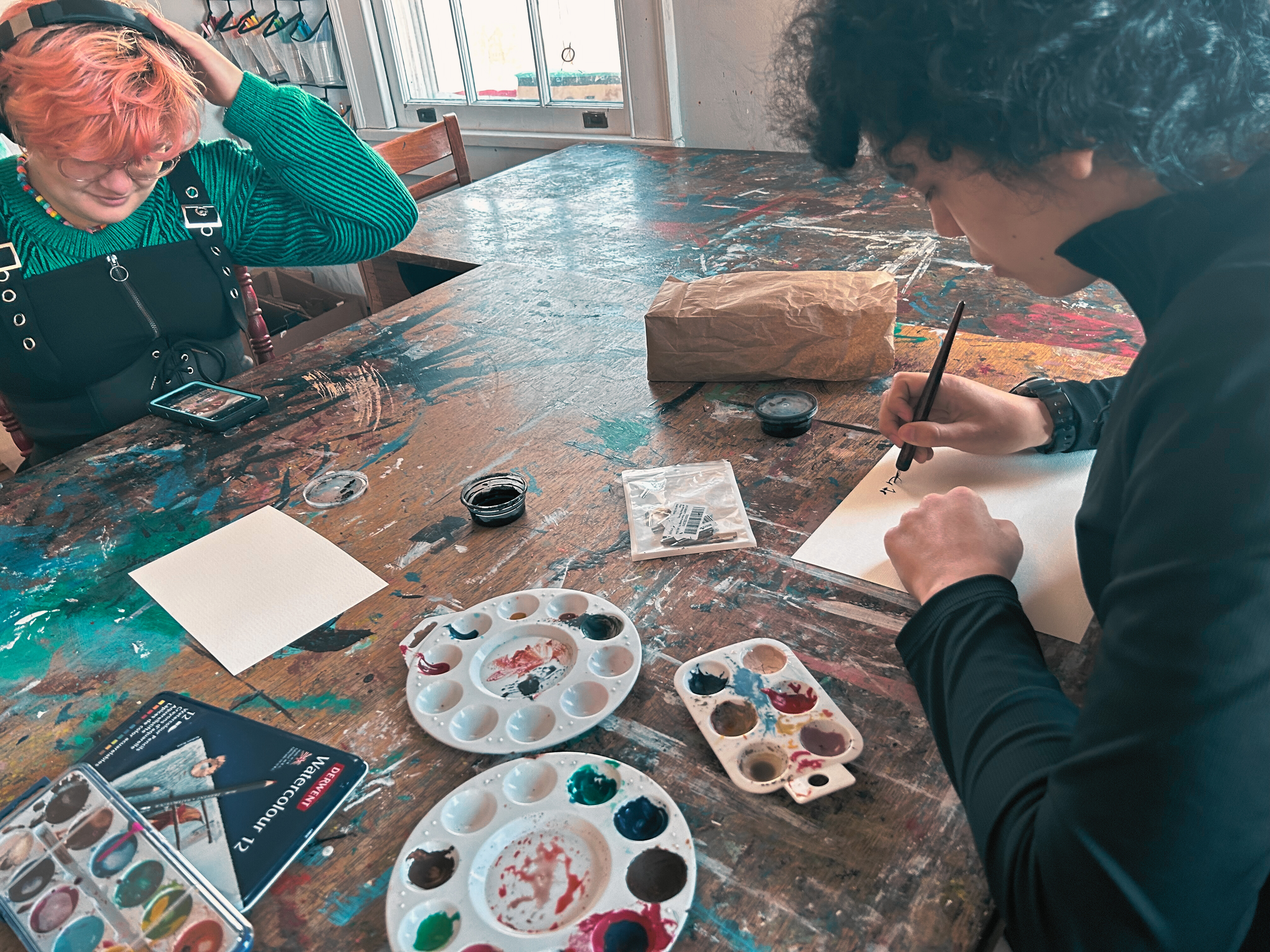 Teens focused on watercolor painting